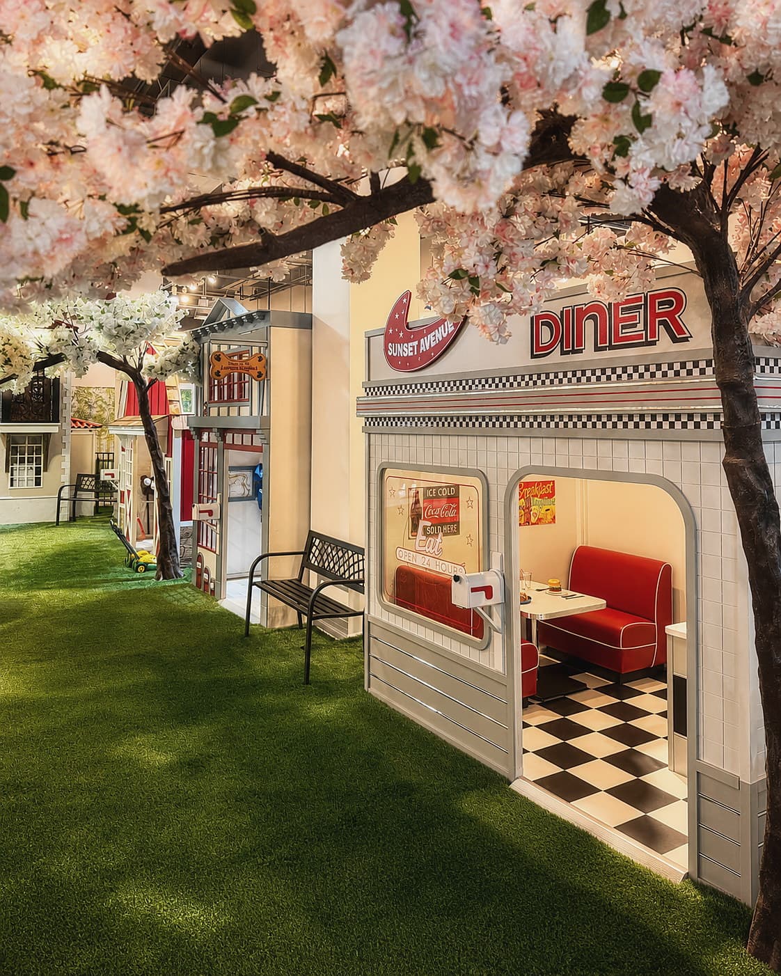 The Sunset Avenue Diner play area under blooming cherry-blossom trees